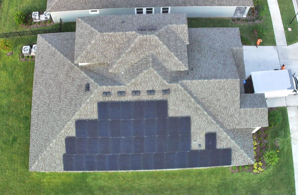 Aerial view of an all-black residential solar installation on a Florida home by May Electric Solar